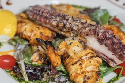 Grilled octopus over greens