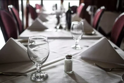 Dining table set with glasses and folded napkins